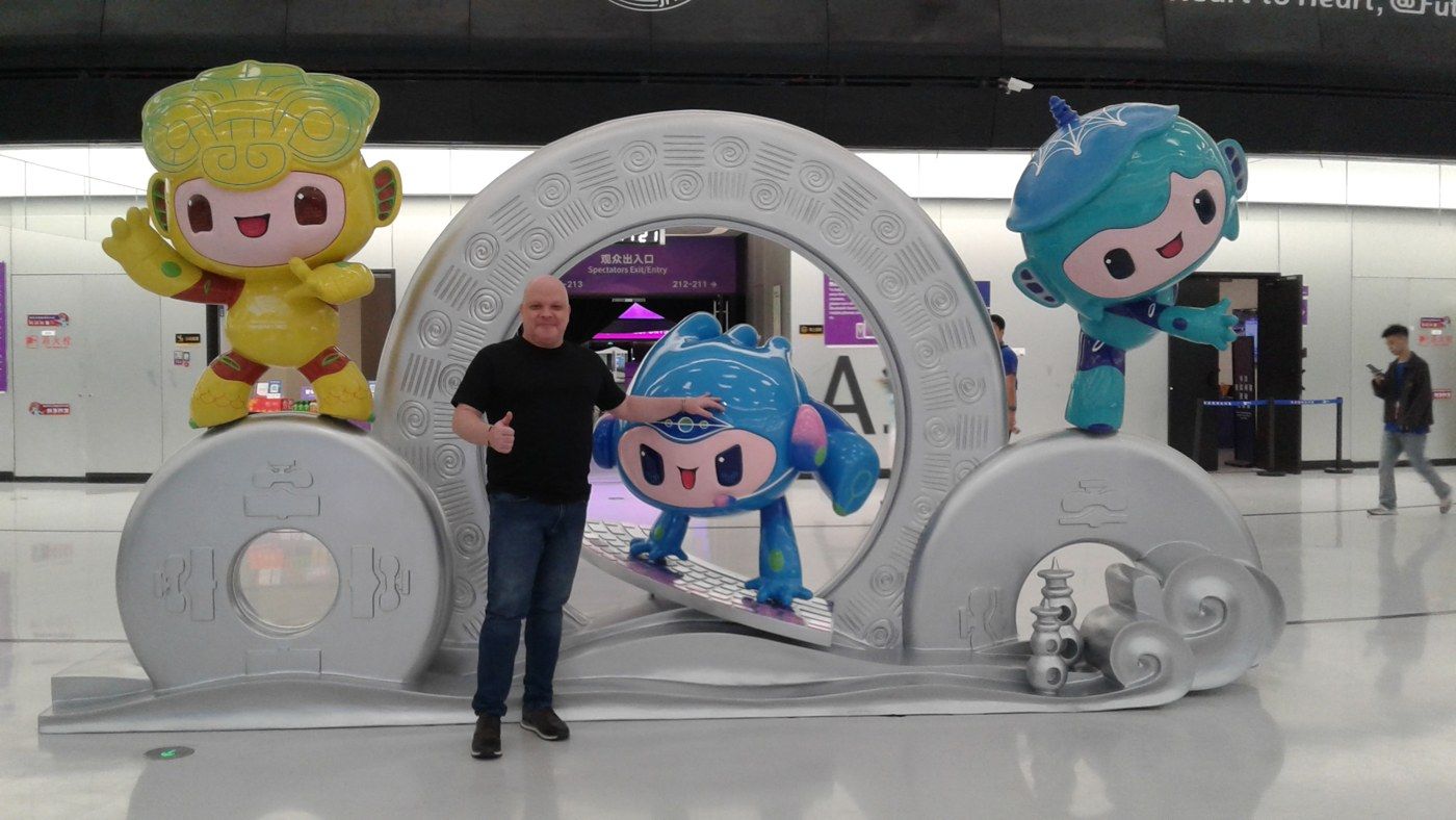Daniel Cossi with the mascots of the 19th Asian Games